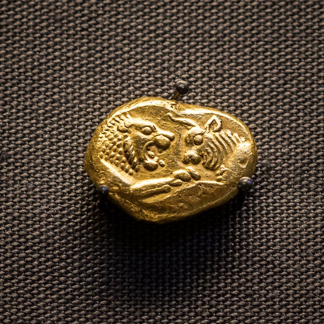 A gold stater struck for Croesus at Sardis, about 560–547 BC, with the confronted foreparts of a lion and a bull.